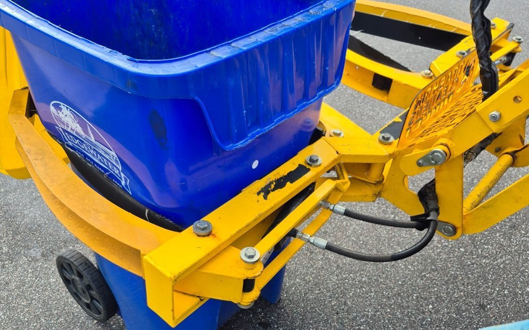 A trash bin loaded into the Lift Off bin-cleaning lifter